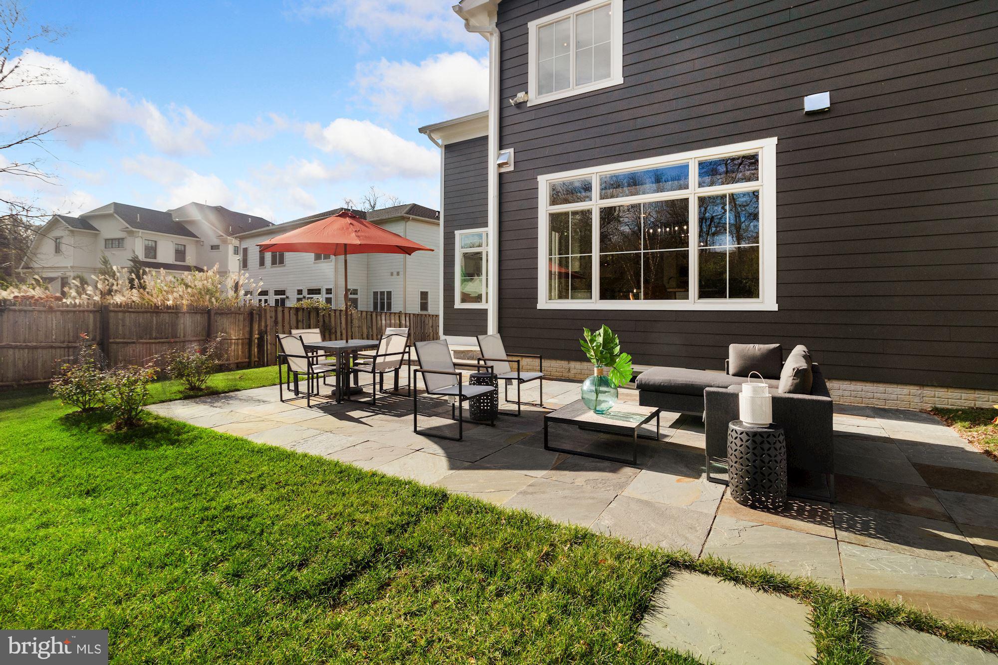7811 Aberdeen Road Bethesda, MD 20814 - Photo 11 of 18 a view of a patio with couches and a table and chairs with the garden