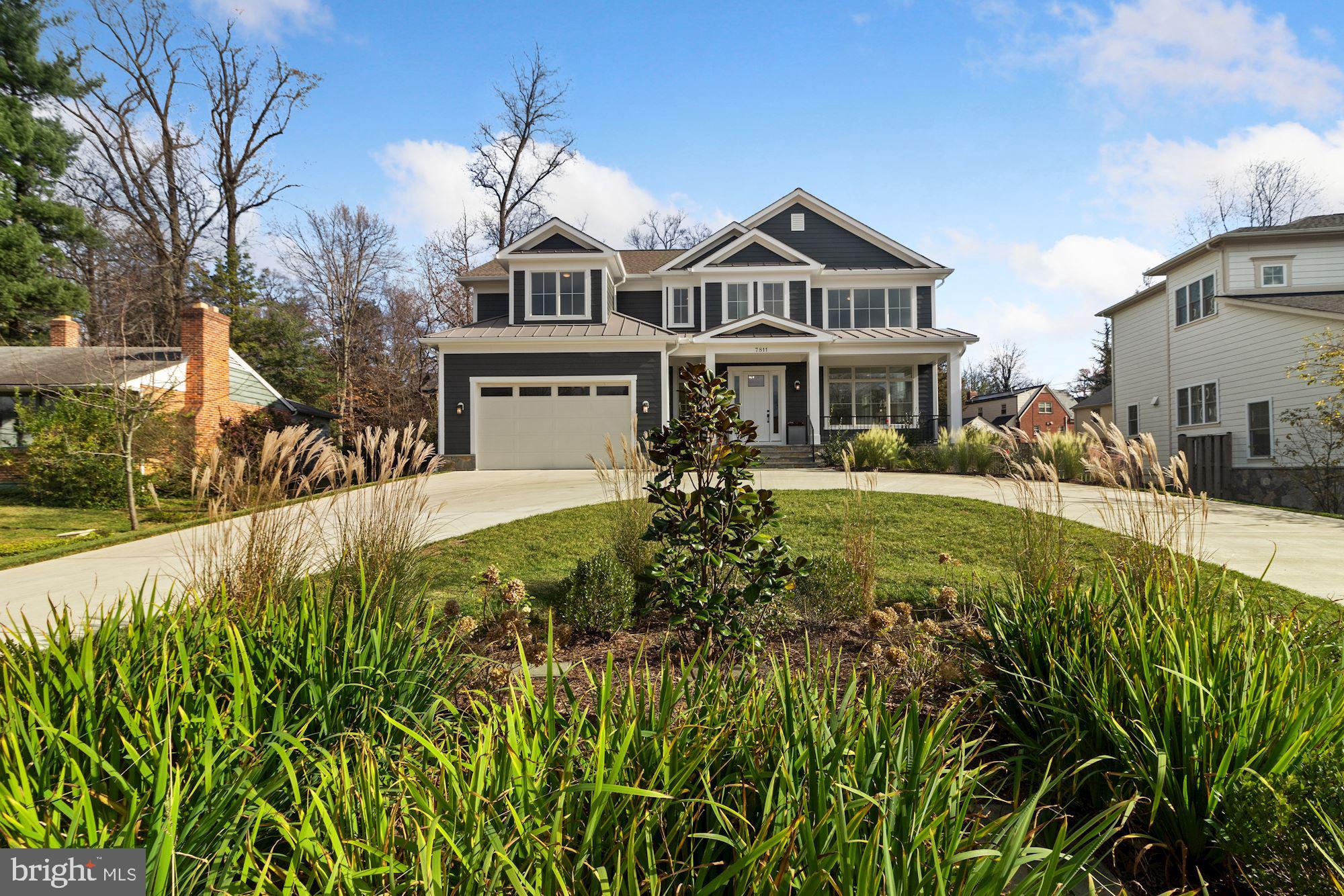 7811 Aberdeen Road Bethesda, MD 20814 - Photo 3 of 18 a front view of a house with a yard table and chairs