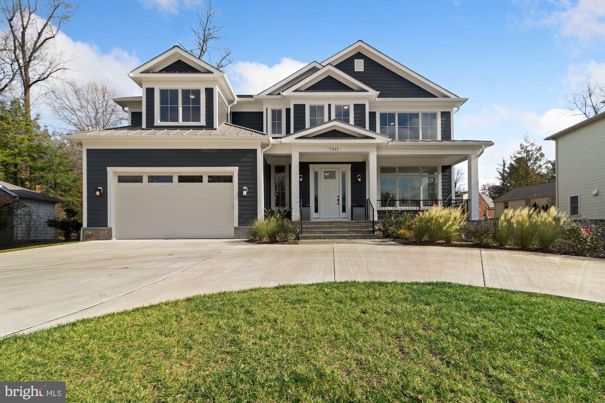7811 Aberdeen Road Bethesda, MD 20814 - Photo 5 of 18 a front view of a house with a yard and garage