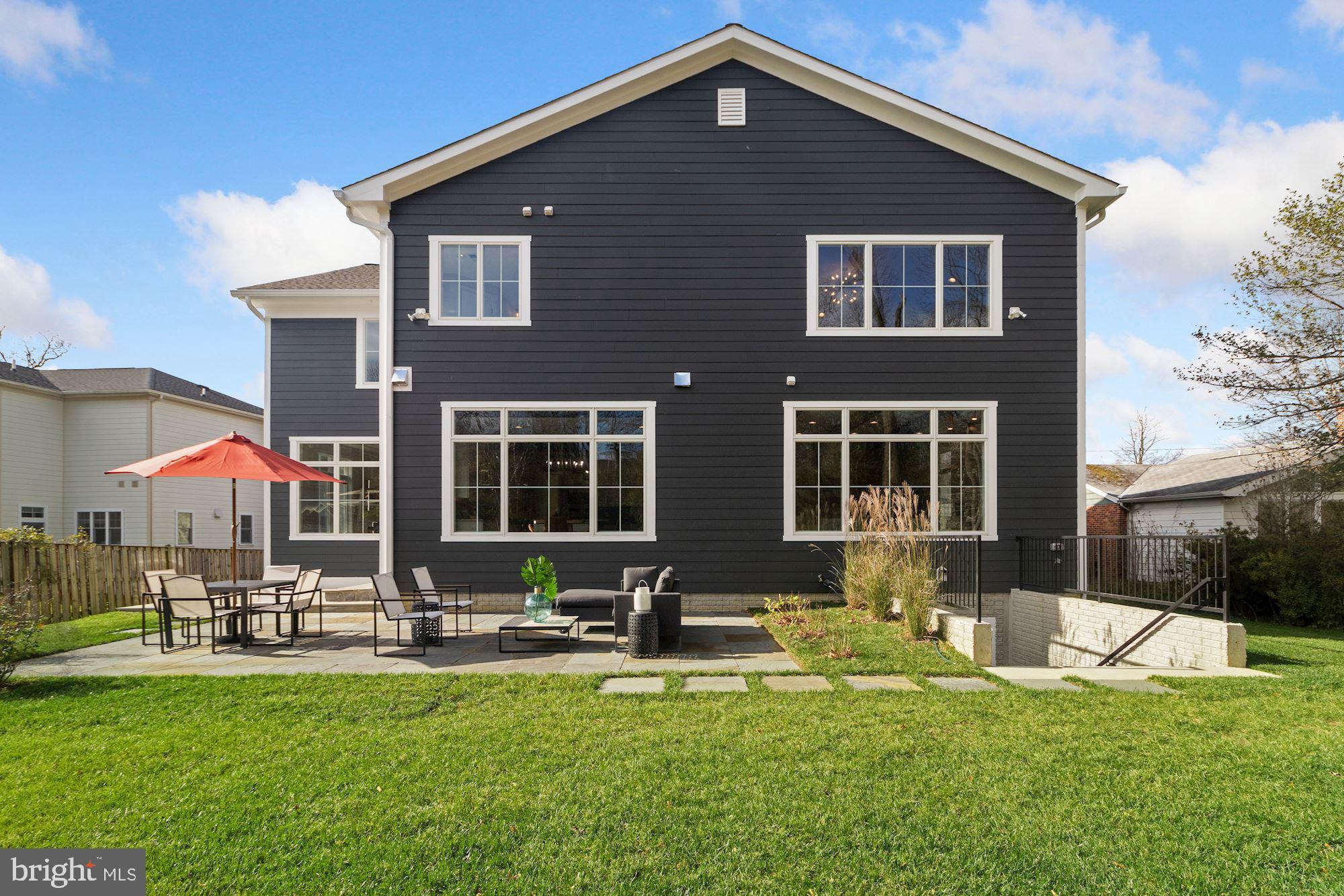 7811 Aberdeen Road Bethesda, MD 20814 - Photo 10 of 18 a front view of house with yard and chairs in patio