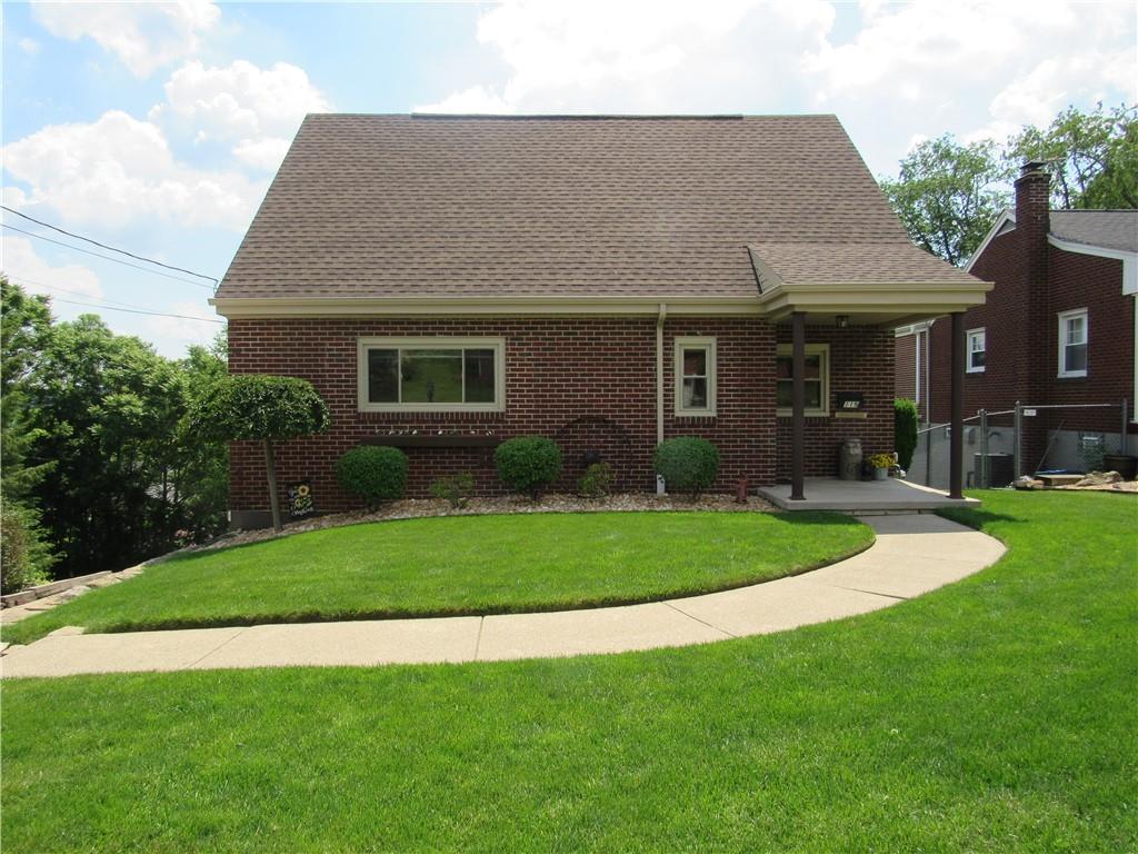 a front view of a house with a garden and plants