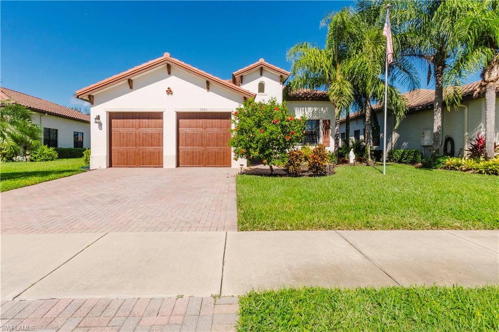 a front view of a house with a yard and garage