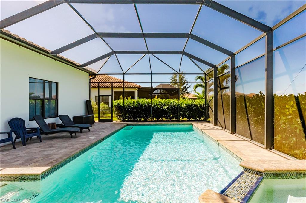 5265 Messina Street Ave Maria, FL 34142 - Photo 16 of 30 a view of a backyard with sitting area