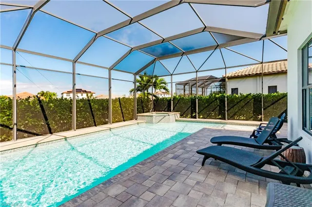 a view of a patio with a table and chairs under an umbrella
