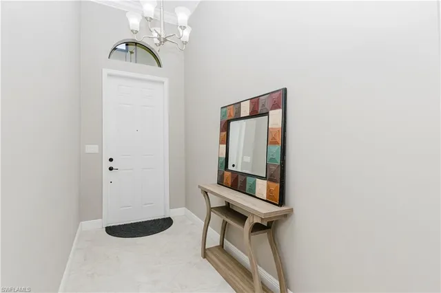 a kitchen with granite countertop a stove a sink and a refrigerator