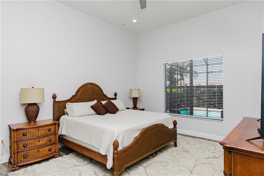 5265 Messina Street Ave Maria, FL 34142 - Photo 21 of 30 a bedroom with a bed a window and dresser