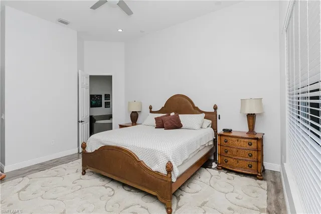 a spacious bathroom with a bathtub a double vanity sink and a mirror