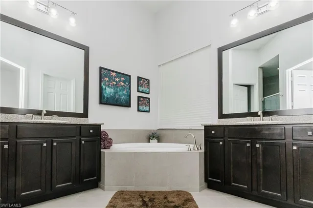 a bathroom with a bathtub sink and mirror