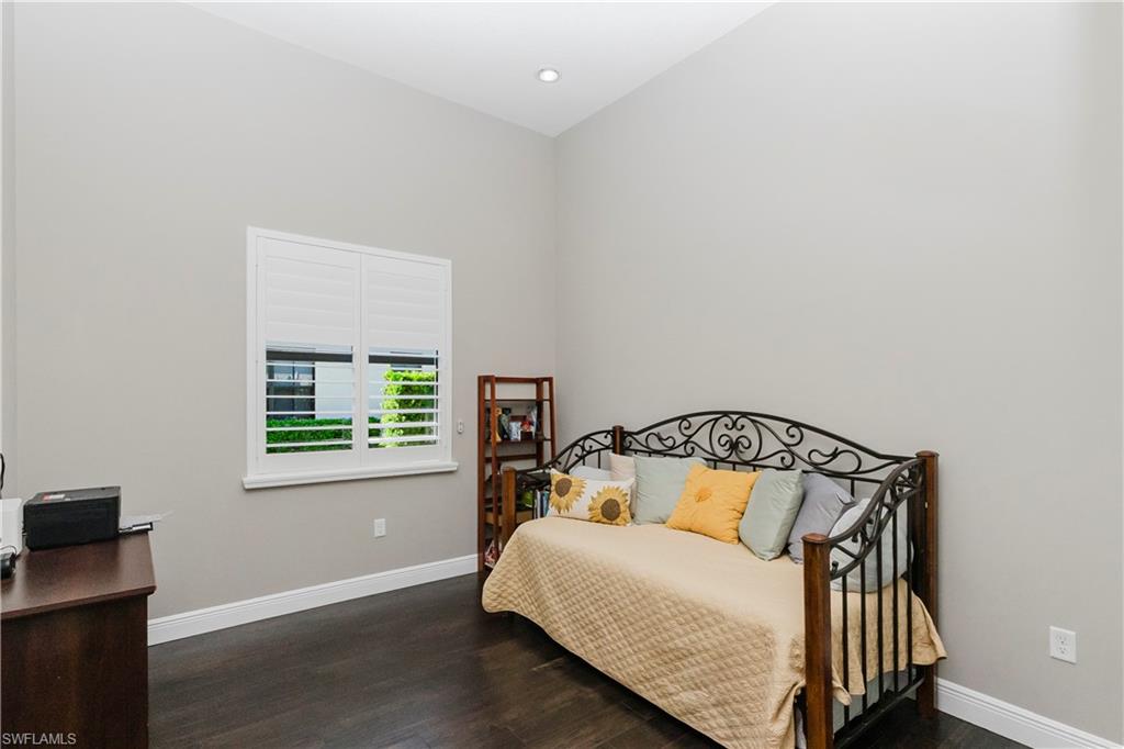 5265 Messina Street Ave Maria, FL 34142 - Photo 25 of 30 a bedroom with a bed and wooden floor