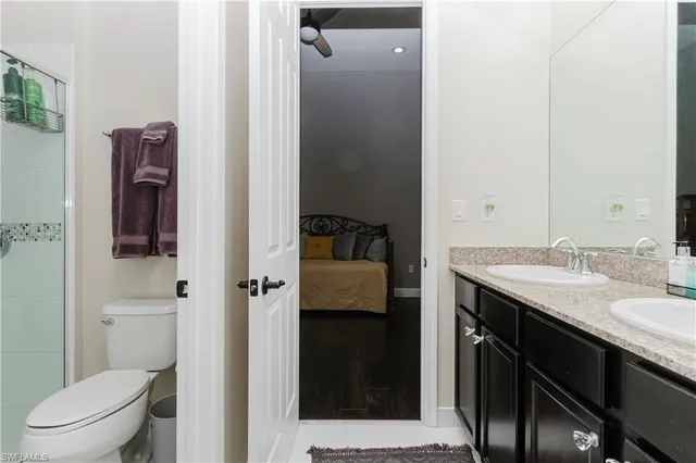 a bedroom with a large bed and a flat tv screen on a dresser