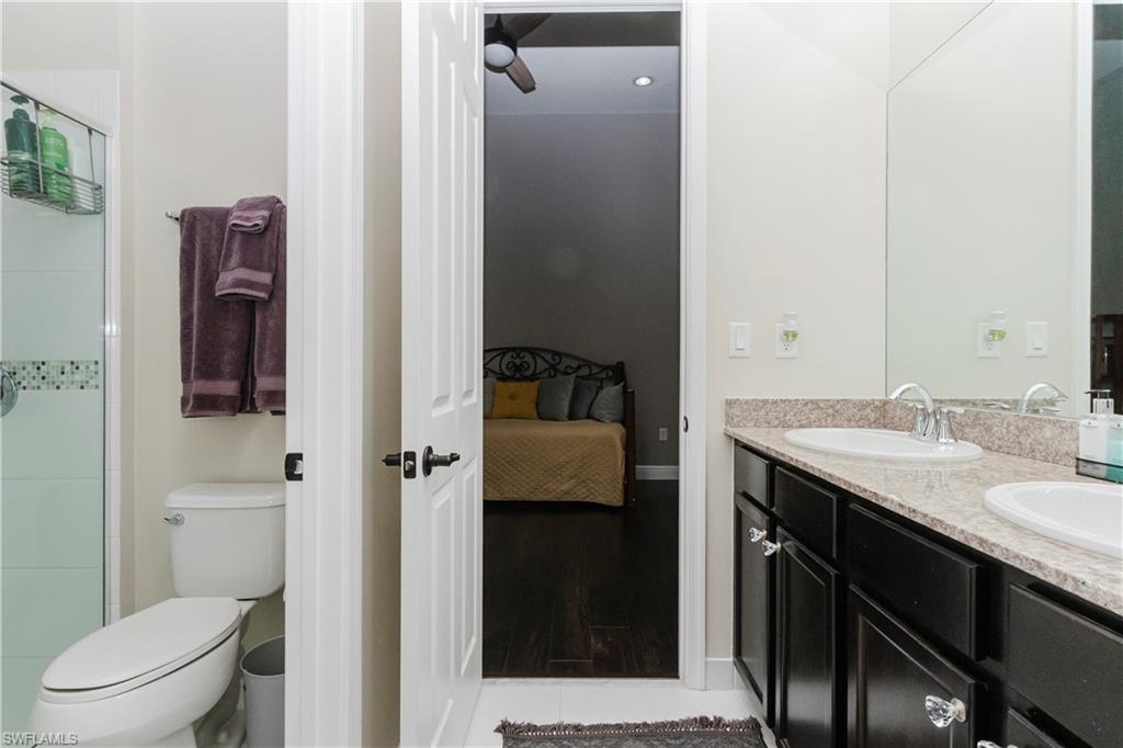 5265 Messina Street Ave Maria, FL 34142 - Photo 28 of 30 a en suite bathroom with a granite countertop sink and a mirror