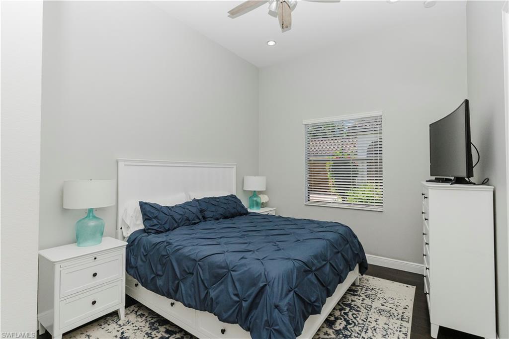 5265 Messina Street Ave Maria, FL 34142 - Photo 29 of 30 a bedroom with a large bed and a flat tv screen on a dresser