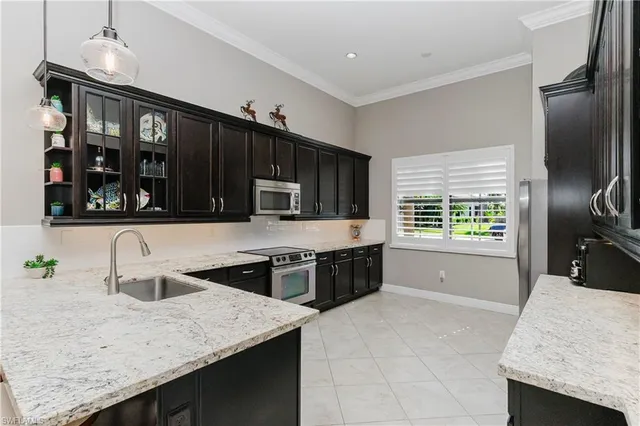 a kitchen with stainless steel appliances granite countertop a stove and a refrigerator
