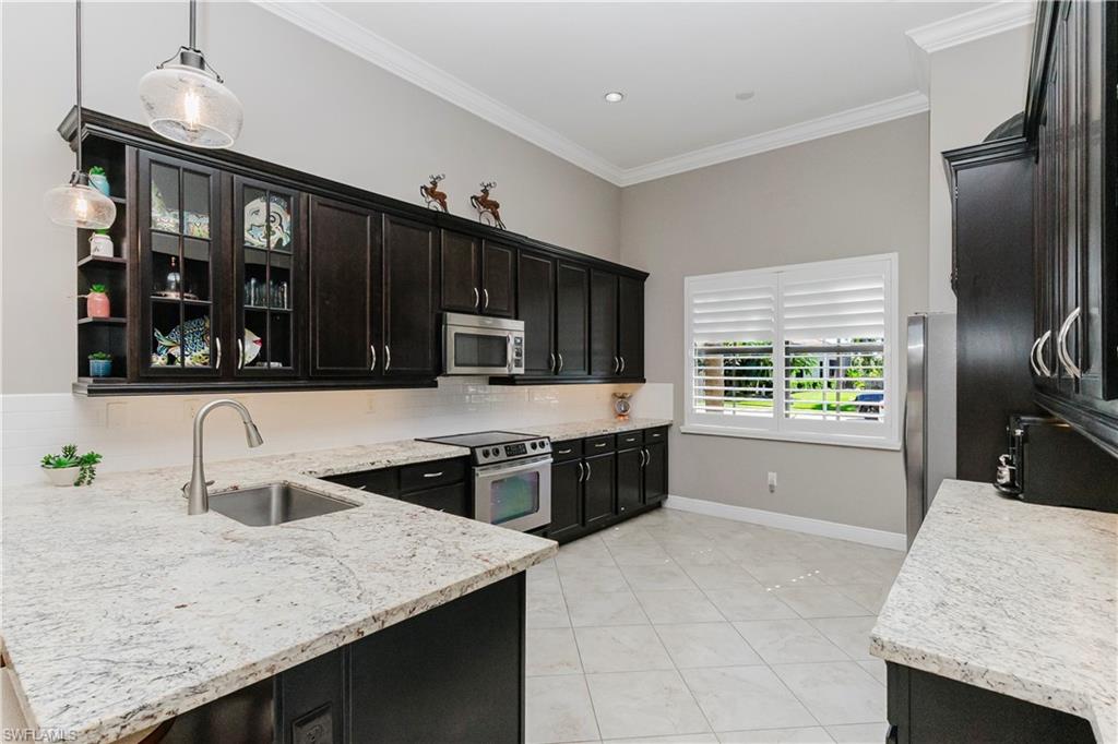 5265 Messina Street Ave Maria, FL 34142 - Photo 4 of 30 a kitchen with a stove a sink and a refrigerator
