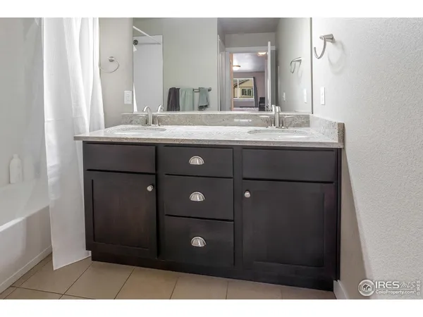 a bathroom with a sink vanity and a mirror