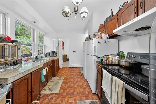 a kitchen with a sink stove and refrigerator