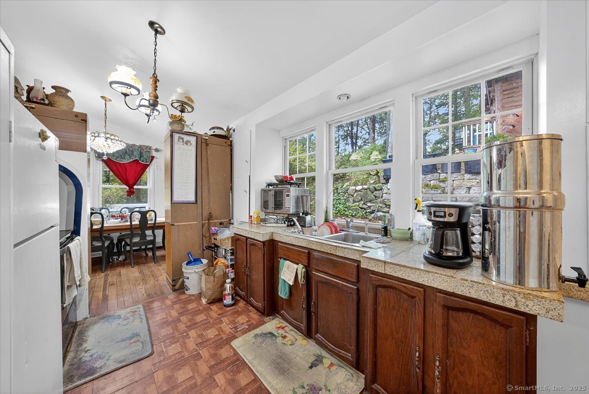 54 Mountain Road Wilton, CT 06897 - Photo 13 of 27 a kitchen with a sink stove and refrigerator