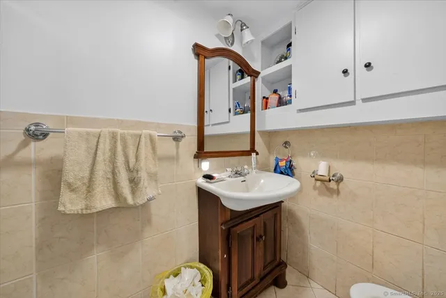 a living room with furniture a rug and gym equipment