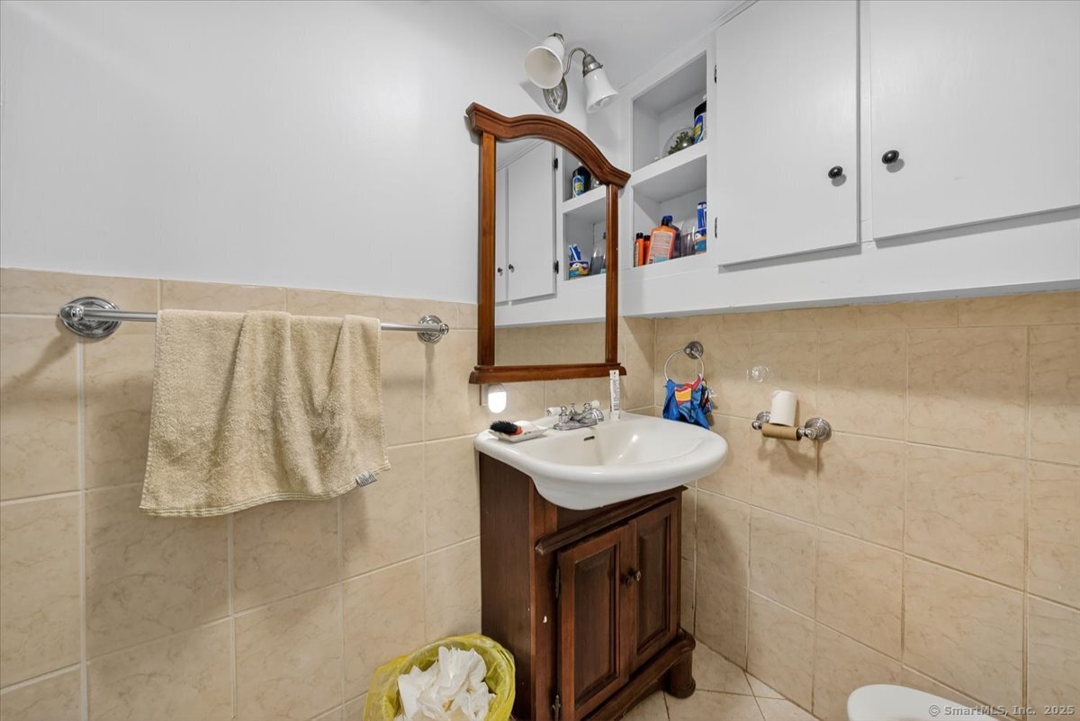 54 Mountain Road Wilton, CT 06897 - Photo 20 of 27 a bathroom with a sink and mirror