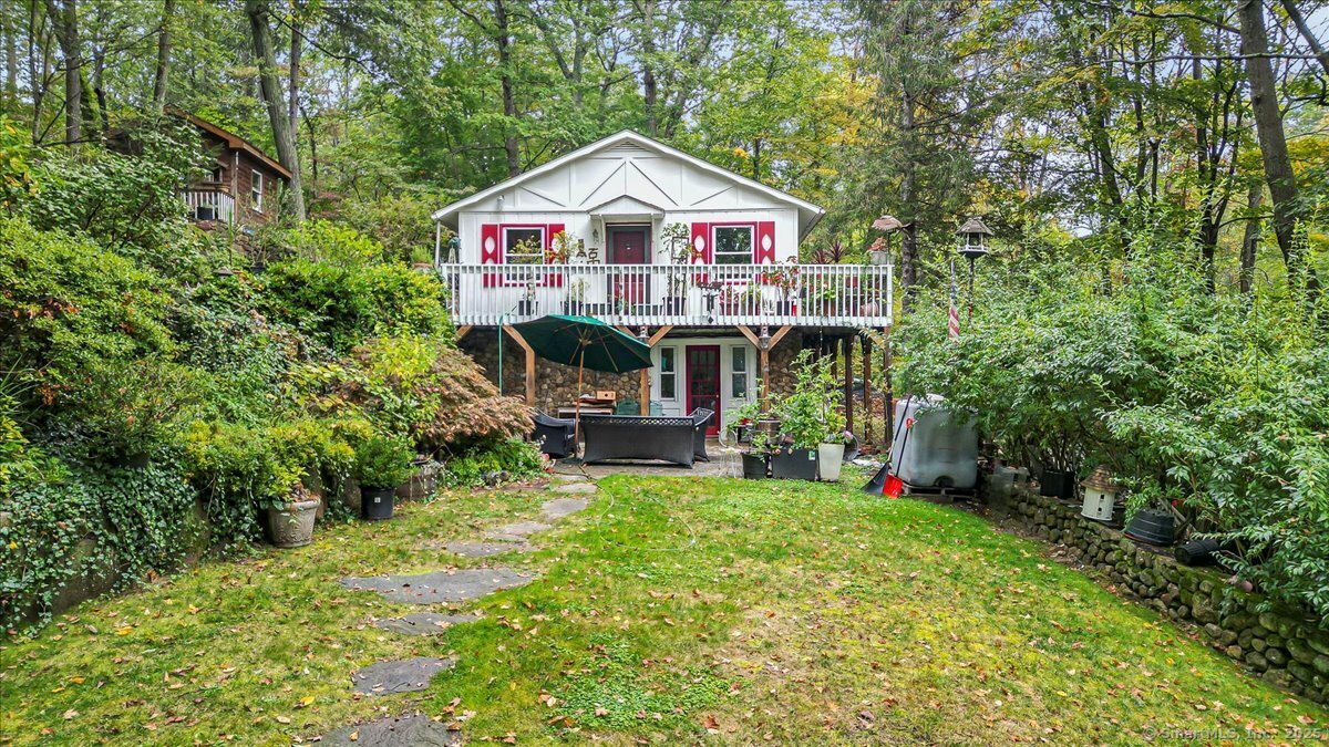 54 Mountain Road Wilton, CT 06897 - Photo 2 of 27 a view of a house with a small yard and sitting area