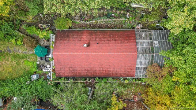 an aerial view of a house with a yard