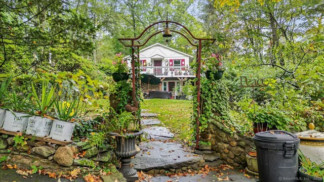 a front view of a house with a yard and trees