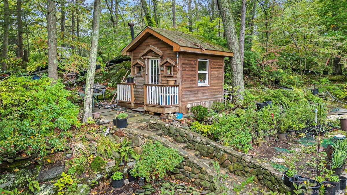 54 Mountain Road Wilton, CT 06897 - Photo 8 of 27 a front view of a house with a yard and trees