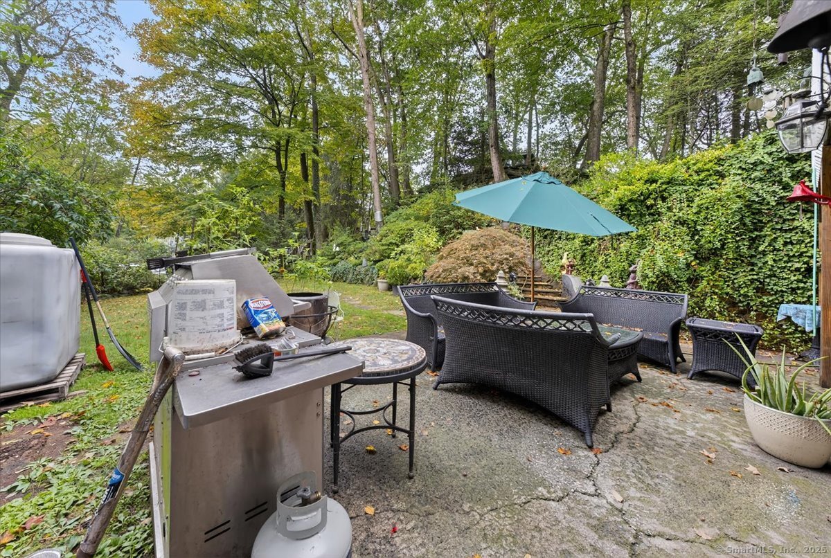 54 Mountain Road Wilton, CT 06897 - Photo 9 of 27 a backyard of a house with table and chairs