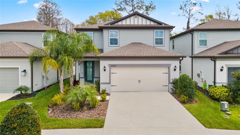 20602 Monza Loop Land O Lakes, FL 34638 - Photo 2 of 44 a front view of a house with garden