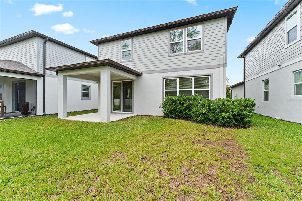 20602 Monza Loop Land O Lakes, FL 34638 - Photo 34 of 44 a view of a house with backyard and garden