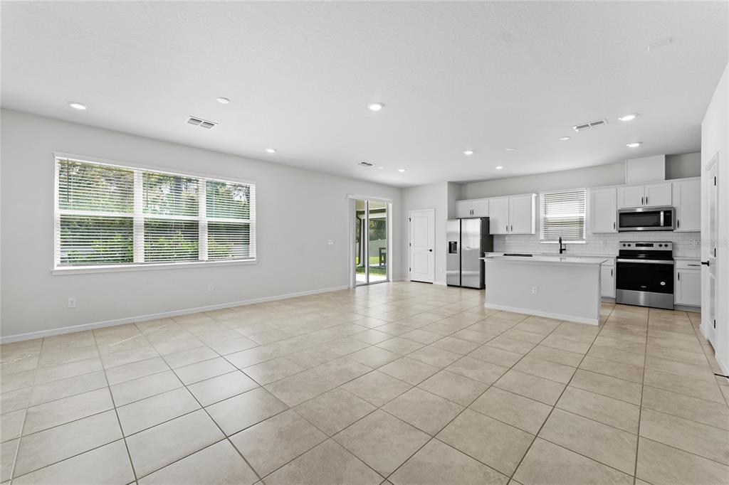20602 Monza Loop Land O Lakes, FL 34638 - Photo 4 of 44 a view of an empty room with kitchen and window