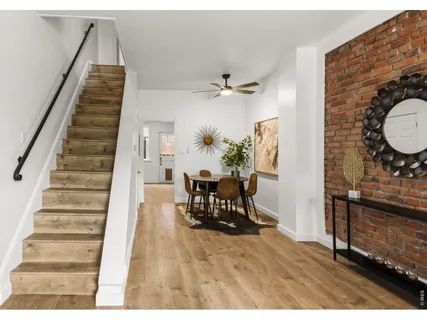 a view of entryway and hall with wooden floor