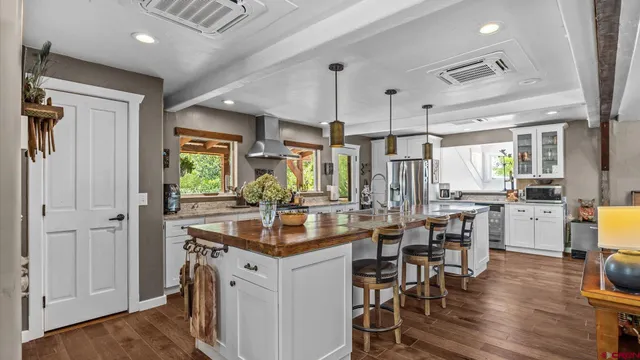 a kitchen with center island table and chairs
