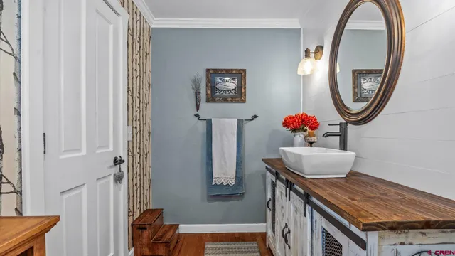 a dining room with furniture and a mirror
