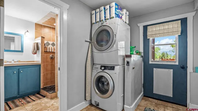 a utility room with sink dryer and washer