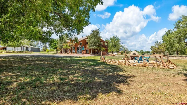 a view of a house with a yard and a garage