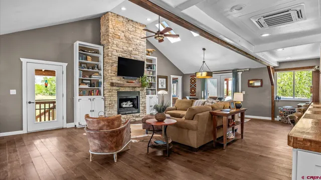 a living room with furniture fireplace and flat screen tv