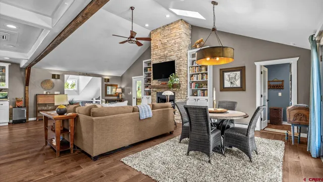 a living room with fireplace furniture and a wooden floor