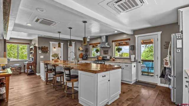 a kitchen with lots of counter top space and wooden floor