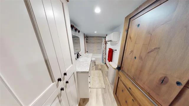 a view of a hallway with wooden floor and stairs