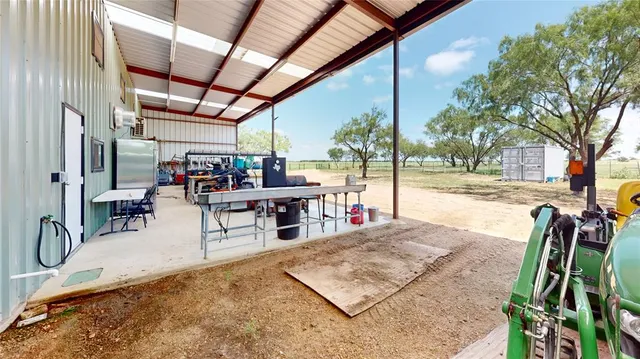 a view of a balcony with chairs and wooden floor