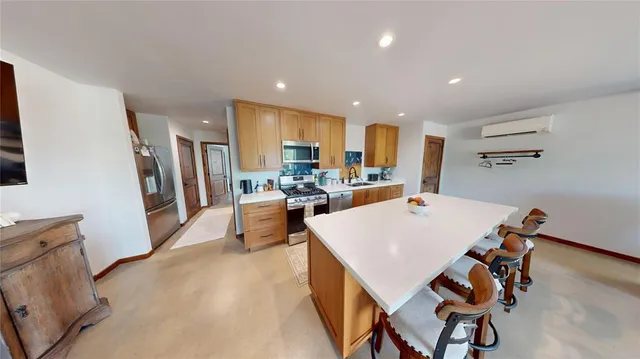 a large kitchen with a table and chairs