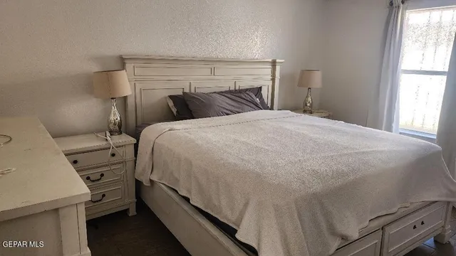 a bed sitting in a bedroom next to a window