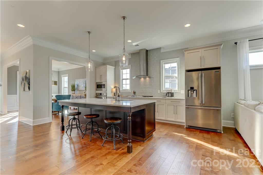 570 Crawfish Drive Fort Mill, SC 29708 - Photo 11 of 48 a kitchen with stainless steel appliances granite countertop a refrigerator a stove a sink dishwasher and a dining table with wooden floor