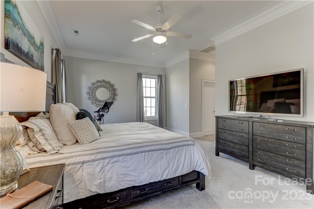 570 Crawfish Drive Fort Mill, SC 29708 - Photo 22 of 48 a bedroom with a large bed and a flat tv screen on dresser
