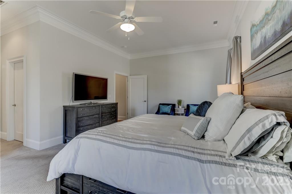 570 Crawfish Drive Fort Mill, SC 29708 - Photo 24 of 48 a bedroom with a bed and a flat screen tv