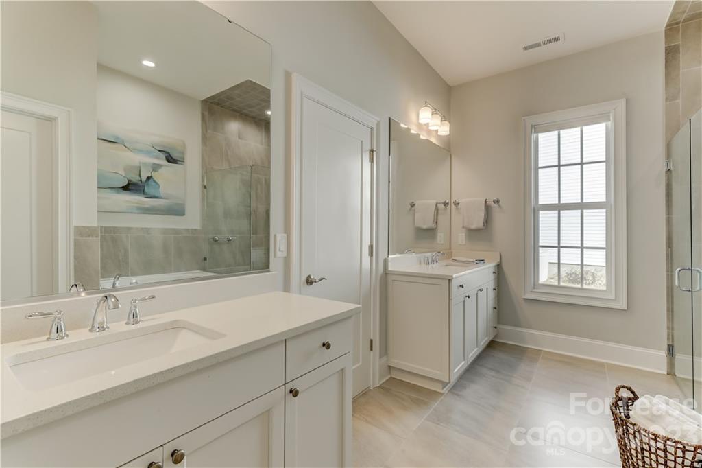 570 Crawfish Drive Fort Mill, SC 29708 - Photo 26 of 48 a bathroom with double vanity sink a mirror and a shower