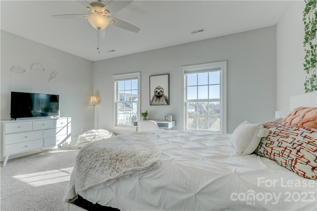 570 Crawfish Drive Fort Mill, SC 29708 - Photo 35 of 48 a spacious bedroom with a large bed a flat tv screen and a dresser