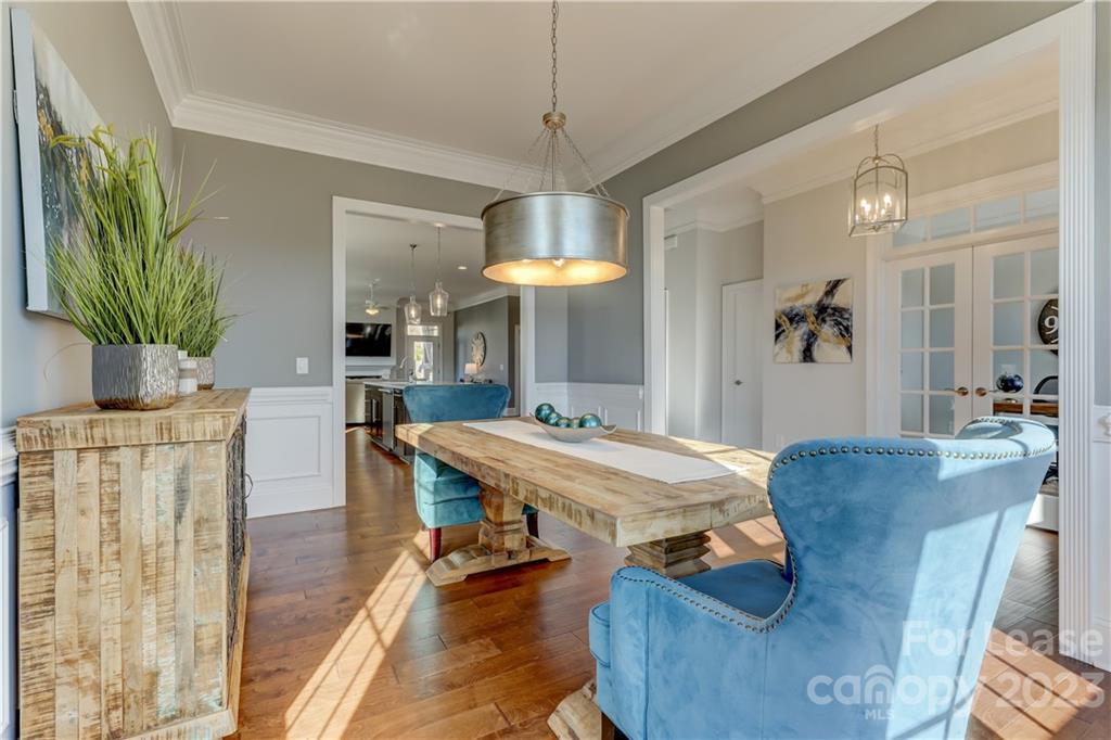 570 Crawfish Drive Fort Mill, SC 29708 - Photo 8 of 48 a dining room with furniture a chandelier and wooden floor