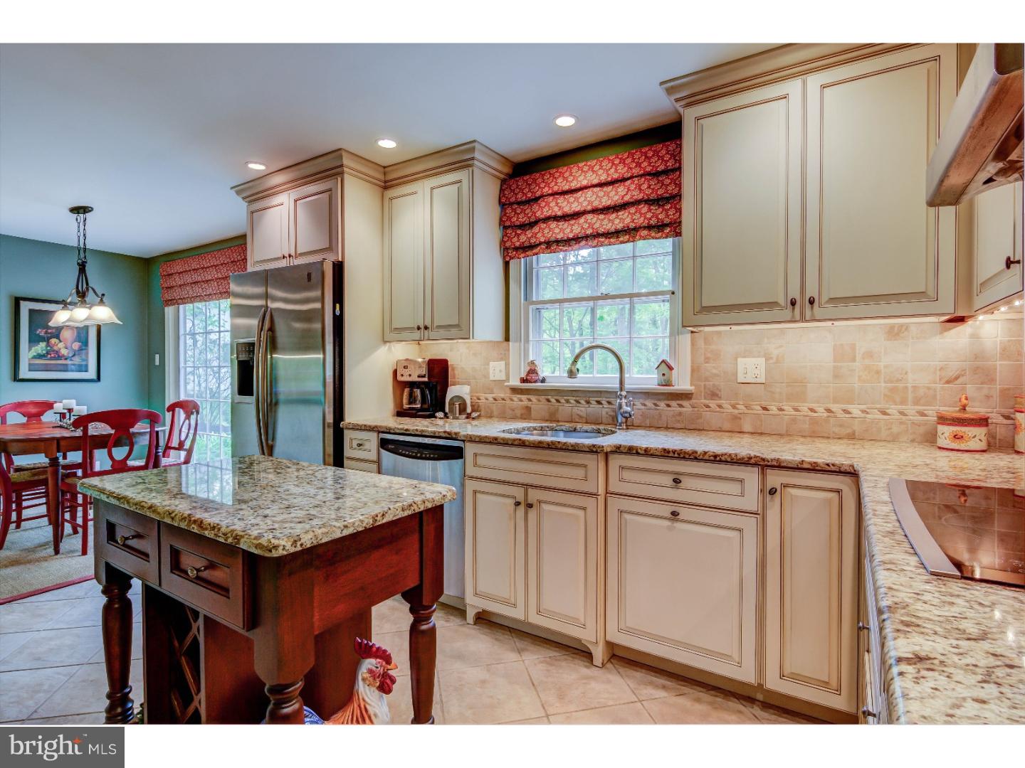 640 Malin Road Newtown Square, PA 19073 - Photo 8 of 24 a kitchen with stainless steel appliances granite countertop a sink dishwasher and a refrigerator with wooden cabinets